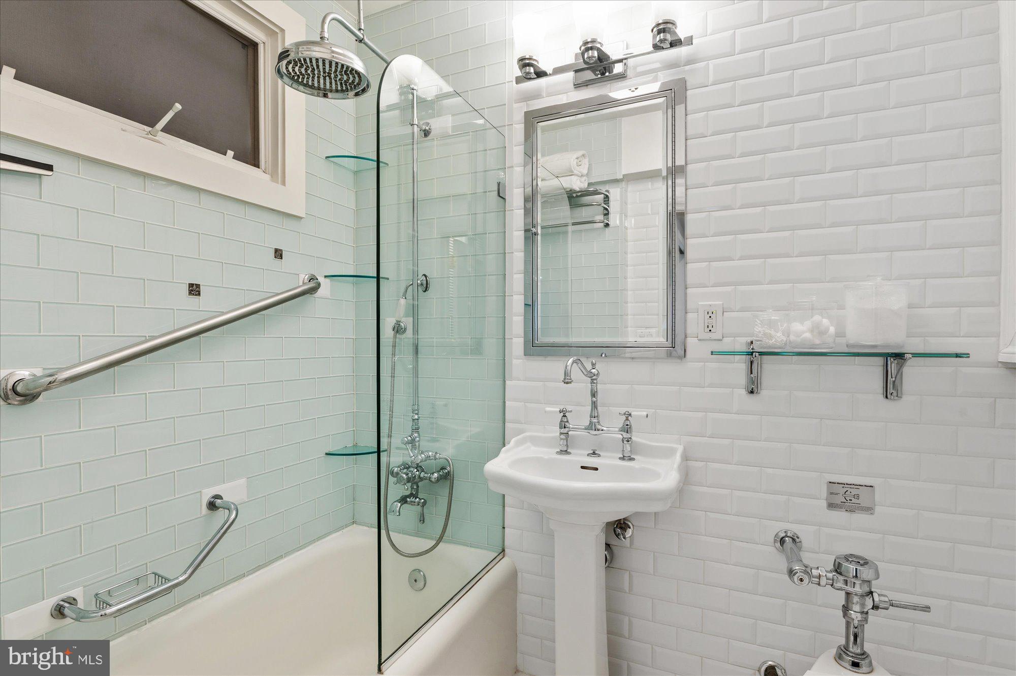 4514 Connecticut Avenue Northwest, Unit 206 Washington, DC 20008 - Photo 16 of 19 a bathroom with a sink mirror and shower