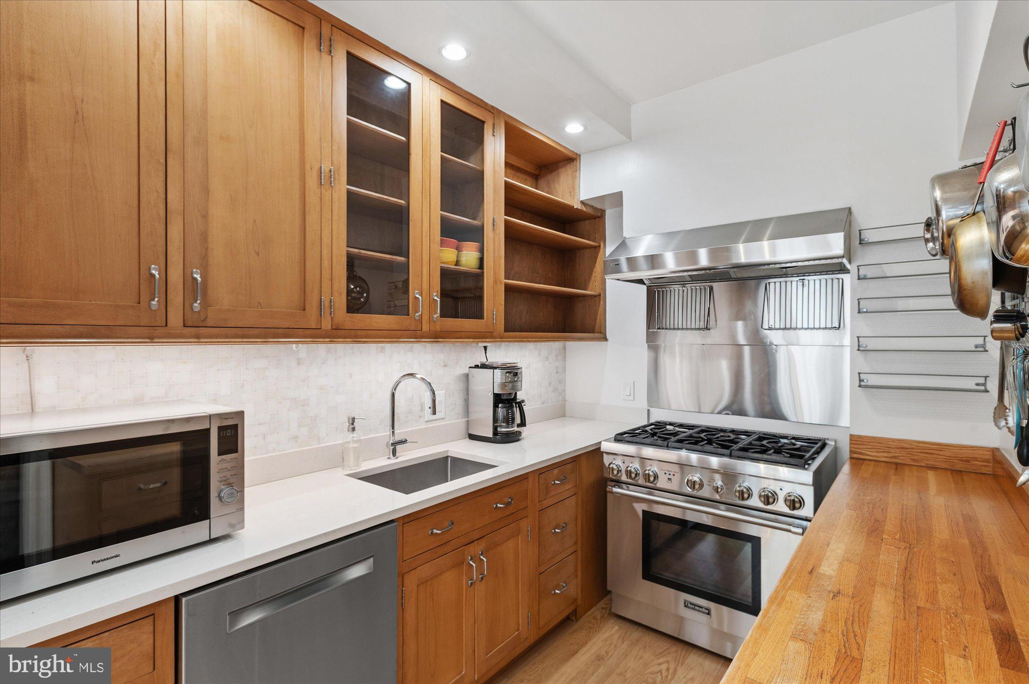 4514 Connecticut Avenue Northwest, Unit 206 Washington, DC 20008 - Photo 10 of 19 a kitchen with stainless steel appliances a stove and a microwave