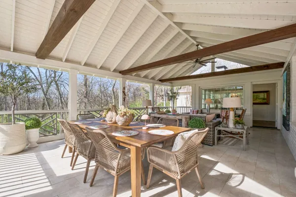 a view of a patio with table and chairs and potted plants