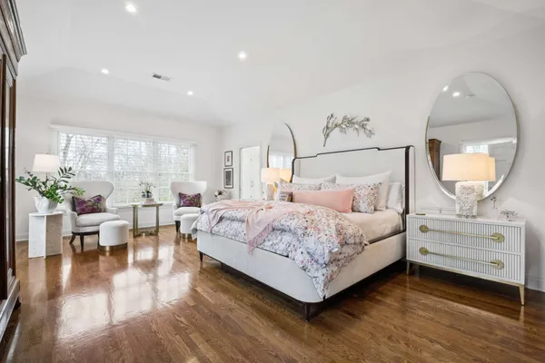 a spacious bedroom with a bed and a large window