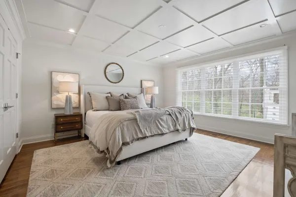 a bedroom with a large bed and a window