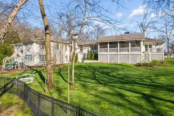 a view of an house with backyard space and balcony