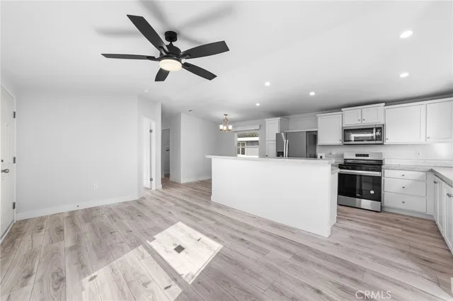 a view of a kitchen with microwave and cabinets