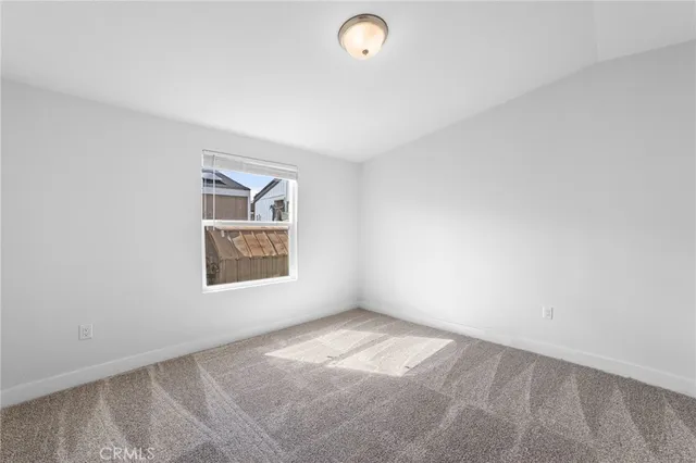 an empty room with windows and painted walls