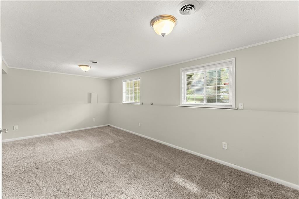 2036 Countydown Lane Stone Mountain, GA 30088 - Photo 17 of 20 an empty room with windows