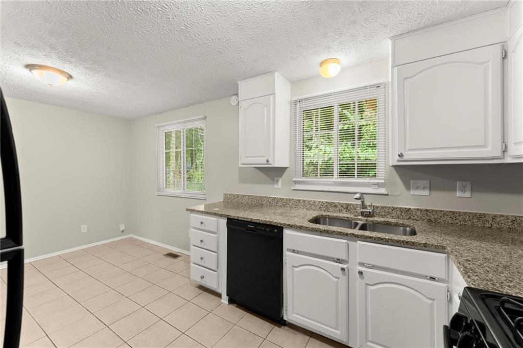 2036 Countydown Lane Stone Mountain, GA 30088 - Photo 8 of 20 a kitchen with a sink cabinets and window