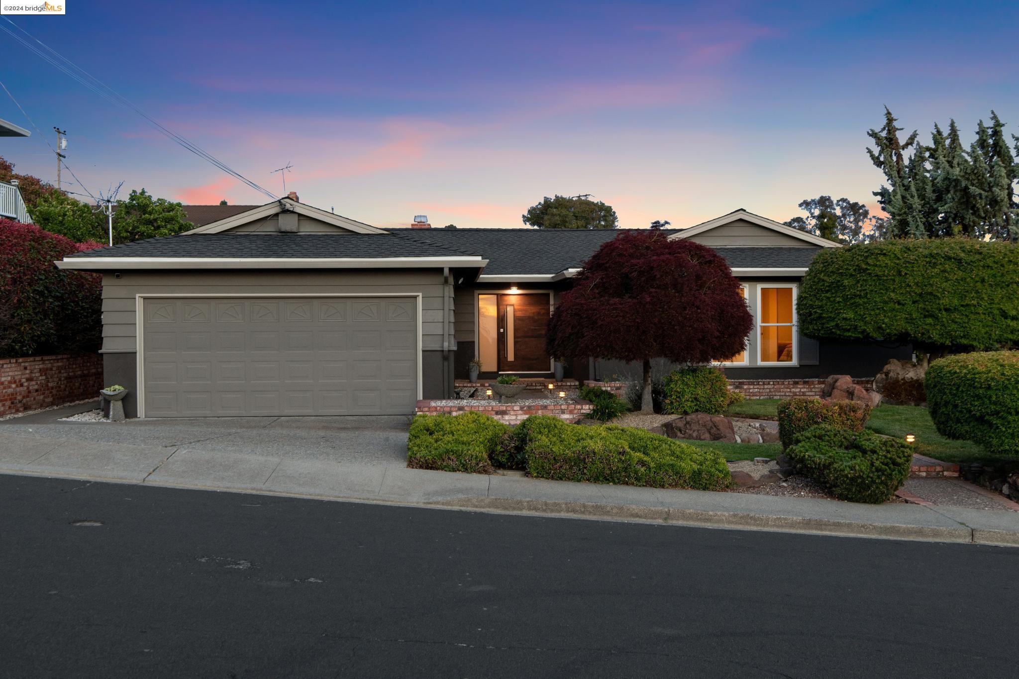 867 Elm Drive Rodeo, CA 94572 - Photo 1 of 1 a front view of a house with a yard and garage