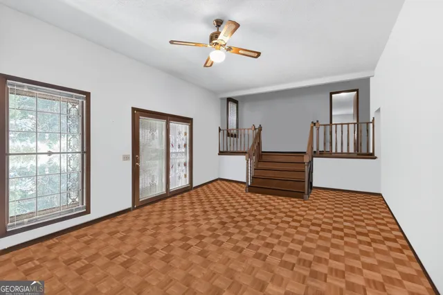 a bedroom with a bed and a painting on the wall