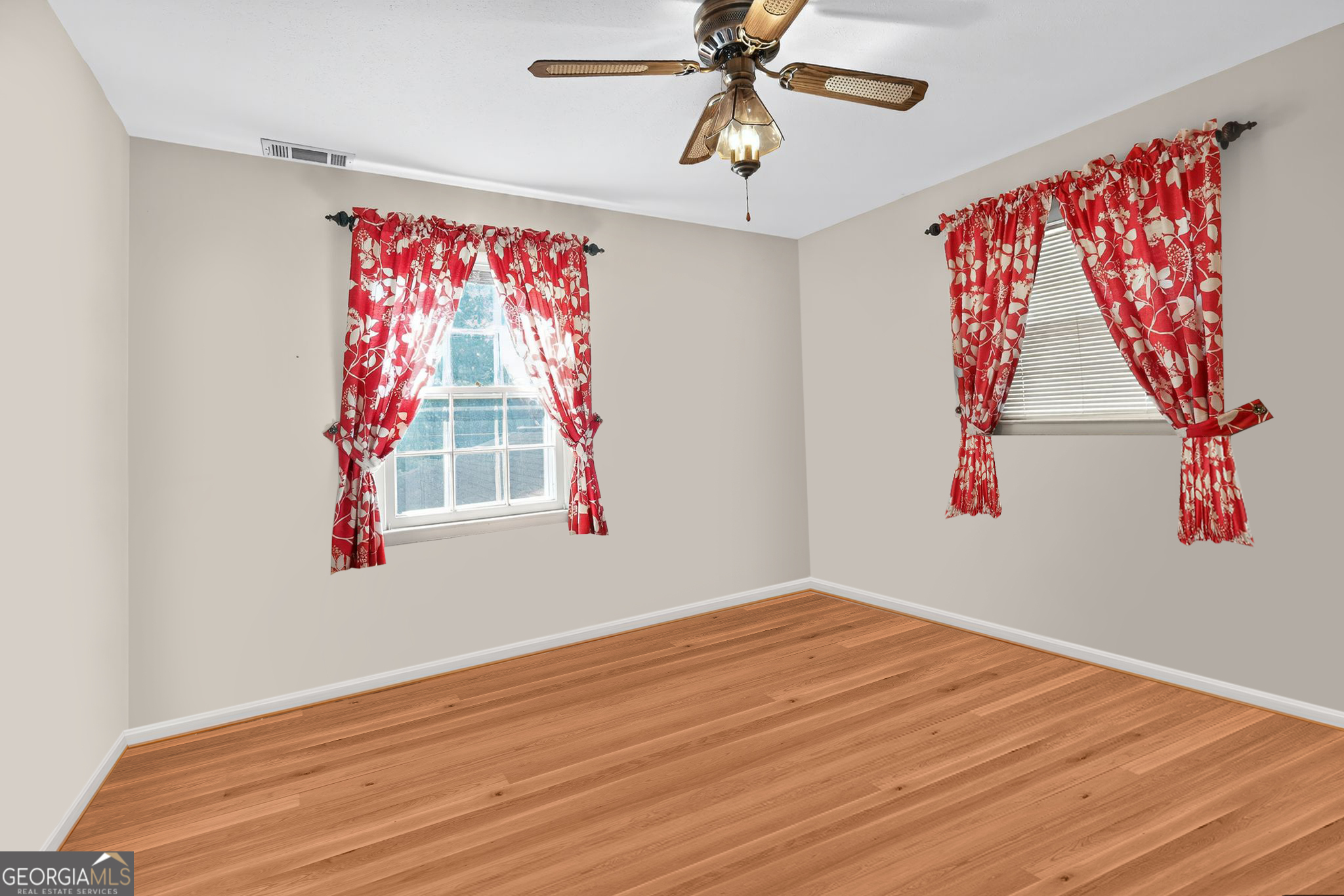 621 Mayes Way Manchester, GA 31816 - Photo 25 of 30 a view of empty room with wooden floor and fan