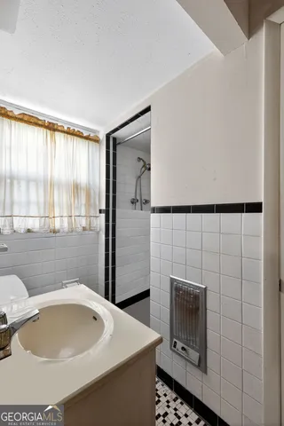 a bathroom with a toilet sink and mirror