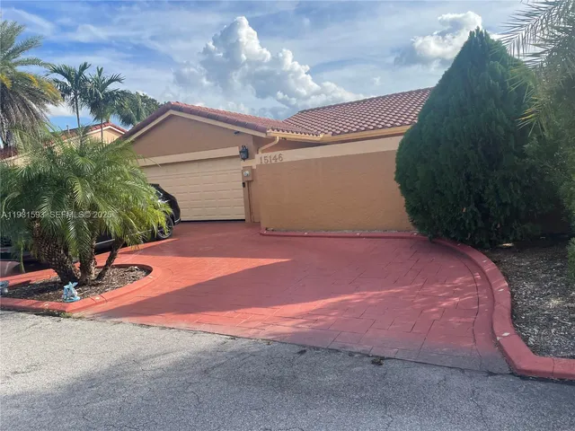 a backyard of a house with table and chairs