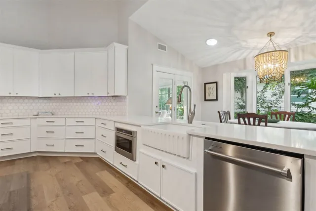 a front view of a house with a garden and trees