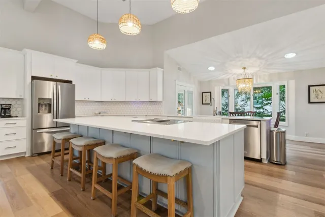 an aerial view of a house with a yard and trees all around
