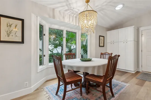 a view of swimming pool with outdoor seating and trees in the background