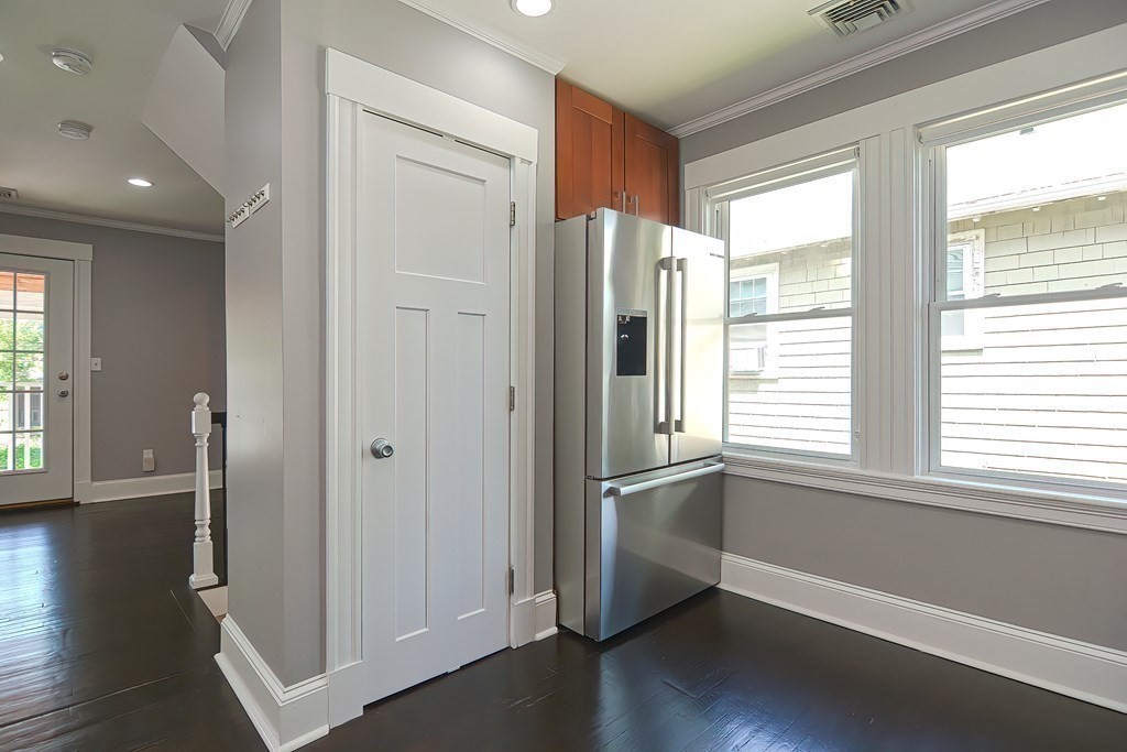 7-9 Goodway Road, Unit 2 Jamaica Plain, MA 02130 - Photo 14 of 39 a view of an empty room with wooden floor and a window