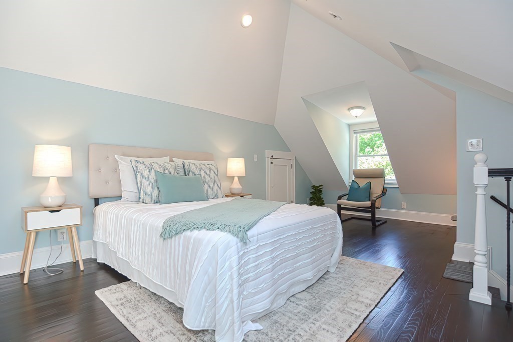 7-9 Goodway Road, Unit 2 Jamaica Plain, MA 02130 - Photo 16 of 39 a spacious bedroom with a bed a lamp on table and a window