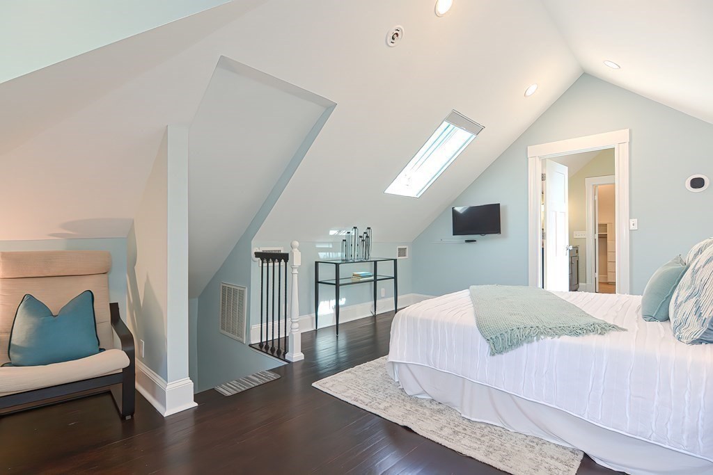 7-9 Goodway Road, Unit 2 Jamaica Plain, MA 02130 - Photo 18 of 39 a bedroom with a large bed and a chandelier