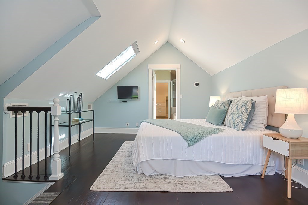 7-9 Goodway Road, Unit 2 Jamaica Plain, MA 02130 - Photo 19 of 39 a spacious bedroom with a bed a table and dresser