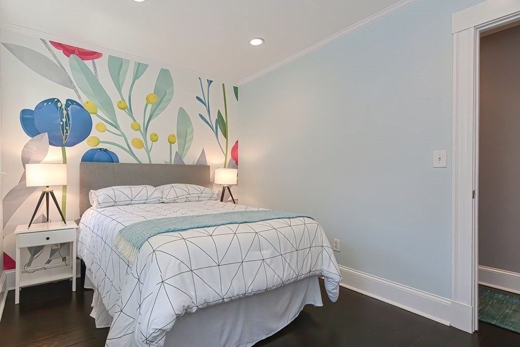 7-9 Goodway Road, Unit 2 Jamaica Plain, MA 02130 - Photo 24 of 39 a bedroom with a bed a painting on the wall and a window