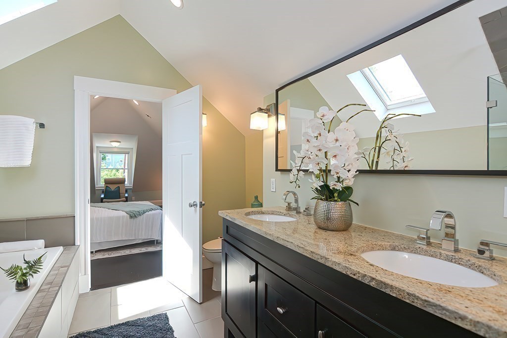 7-9 Goodway Road, Unit 2 Jamaica Plain, MA 02130 - Photo 28 of 39 a en suite bathroom with a granite countertop sink and a mirror