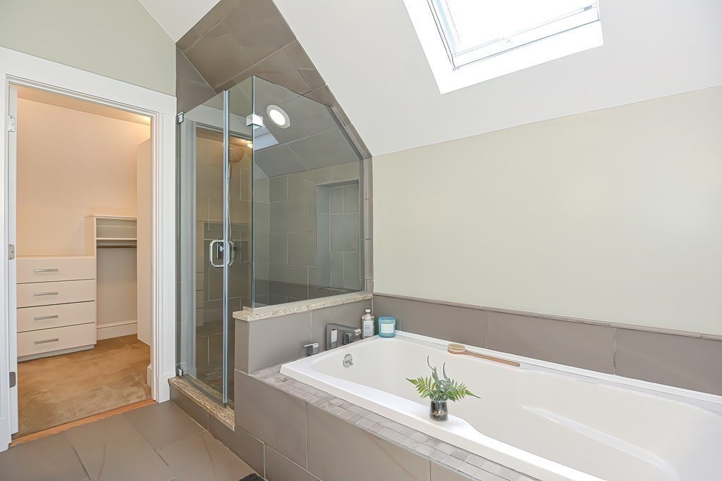 7-9 Goodway Road, Unit 2 Jamaica Plain, MA 02130 - Photo 29 of 39 a bathroom with a tub a sink and a large mirror