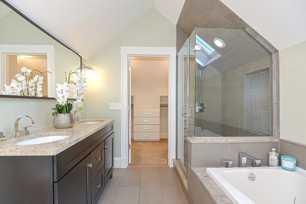 7-9 Goodway Road, Unit 2 Jamaica Plain, MA 02130 - Photo 30 of 39 a bathroom with a tub sink and mirror