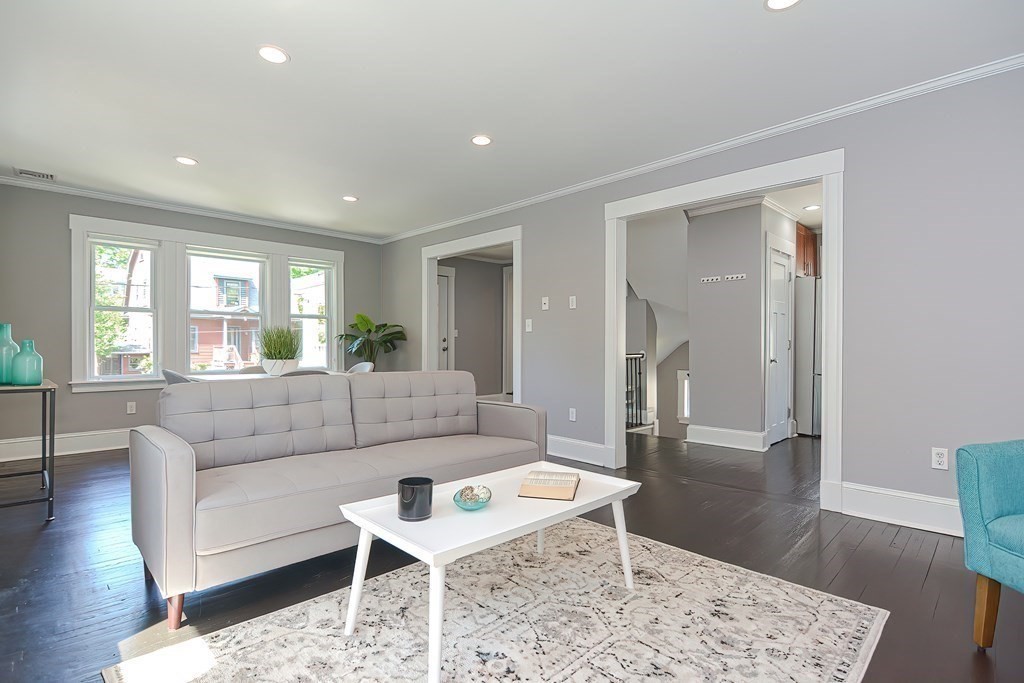 7-9 Goodway Road, Unit 2 Jamaica Plain, MA 02130 - Photo 3 of 39 a living room with furniture and a wooden floor