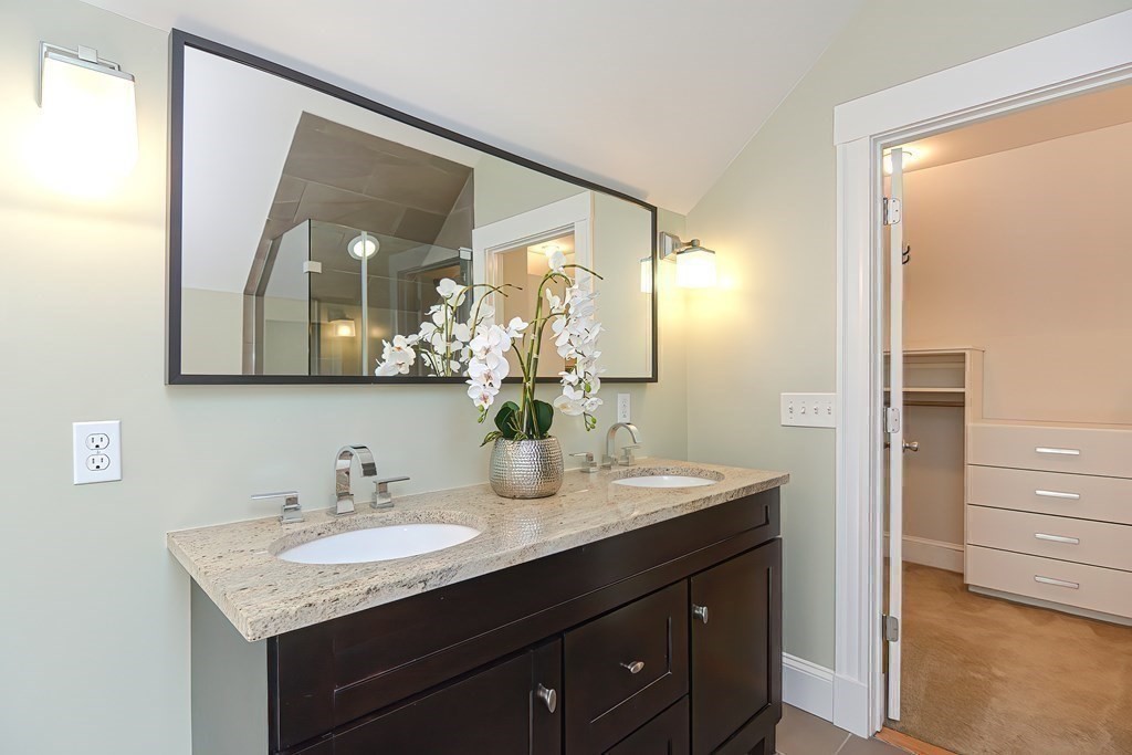 7-9 Goodway Road, Unit 2 Jamaica Plain, MA 02130 - Photo 31 of 39 a bathroom with a granite countertop sink and a mirror
