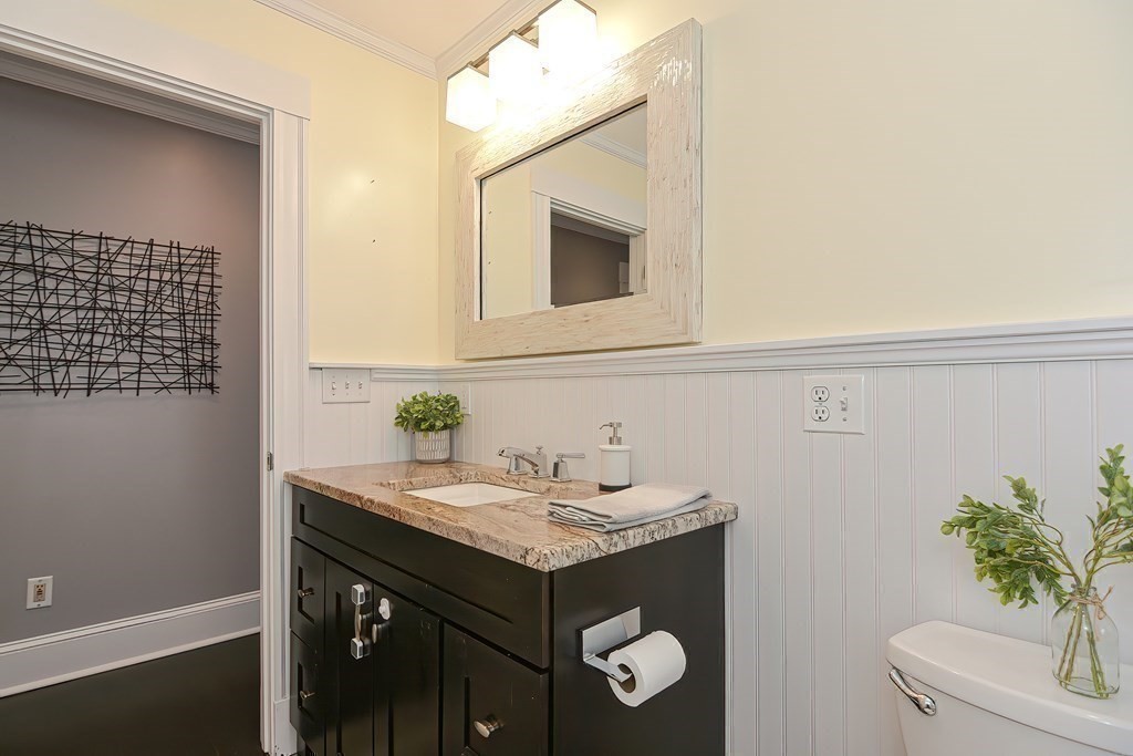 7-9 Goodway Road, Unit 2 Jamaica Plain, MA 02130 - Photo 32 of 39 a bathroom with a granite countertop sink and a mirror