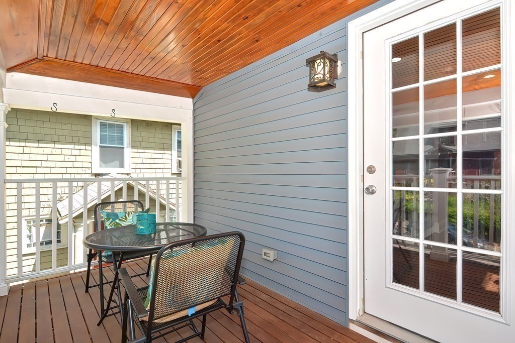 7-9 Goodway Road, Unit 2 Jamaica Plain, MA 02130 - Photo 35 of 39 a view of a balcony with chair and wooden floor