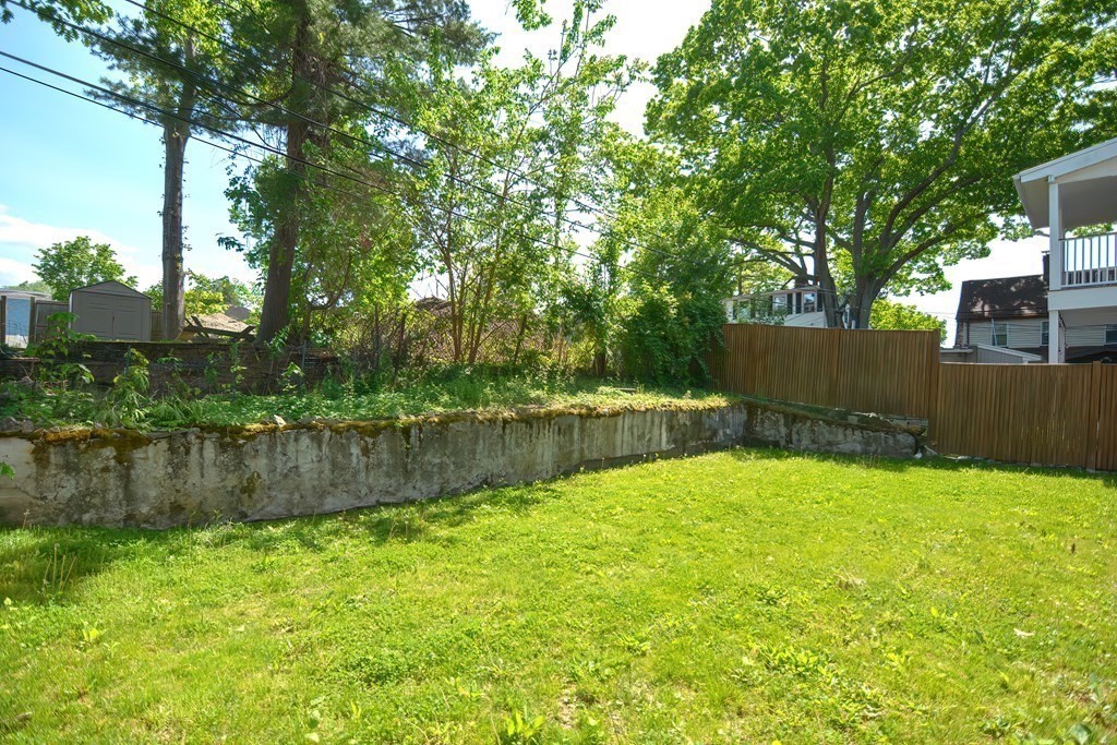 7-9 Goodway Road, Unit 2 Jamaica Plain, MA 02130 - Photo 39 of 39 a swimming pool with wooden fence