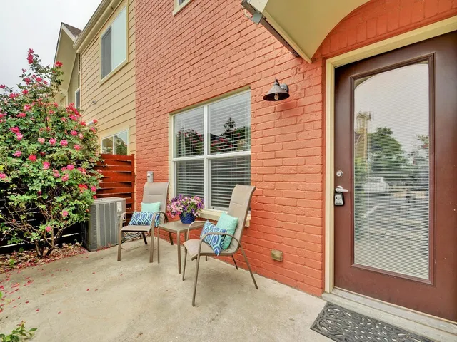 a backyard of a house with outdoor seating