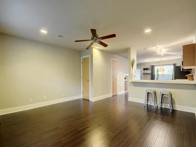 a view of workspace and kitchen with wooden floor