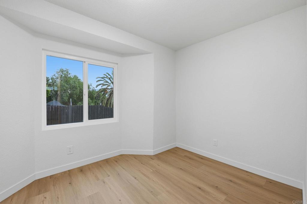 1333 Helix Street Spring Valley, CA 91977 - Photo 33 of 45 a view of an empty room with wooden floor and a window