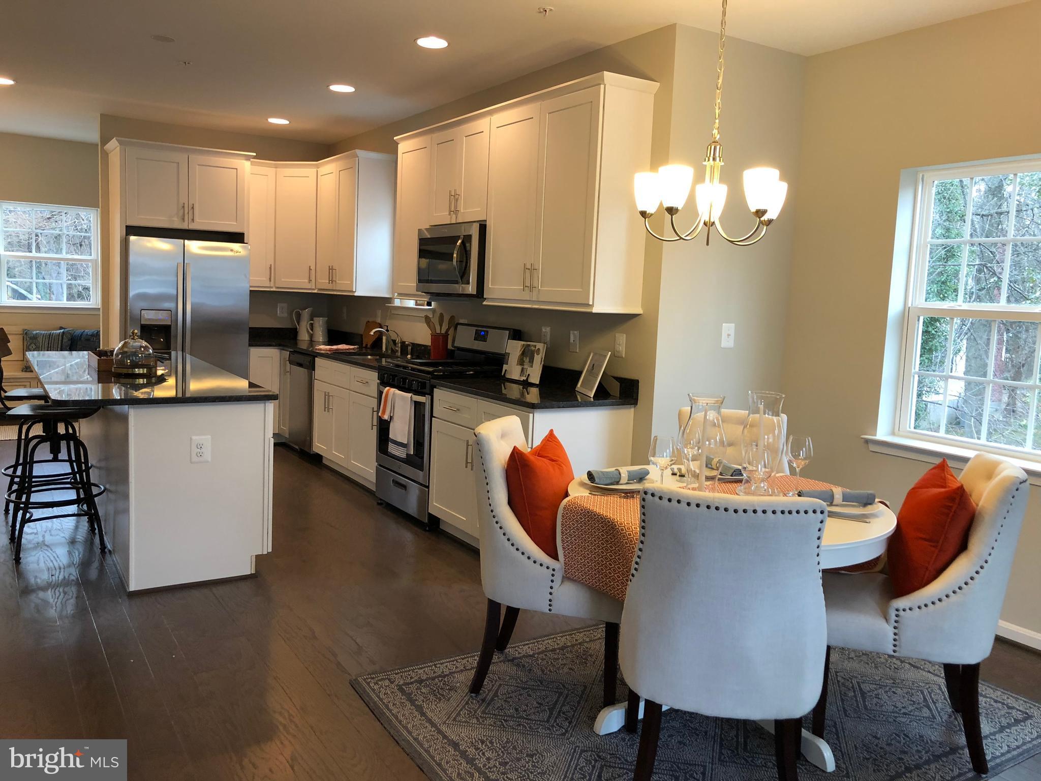 905 Cedarcroft Road Baltimore, MD 21212 - Photo 4 of 28 a dining room filled chandelier and kitchen view