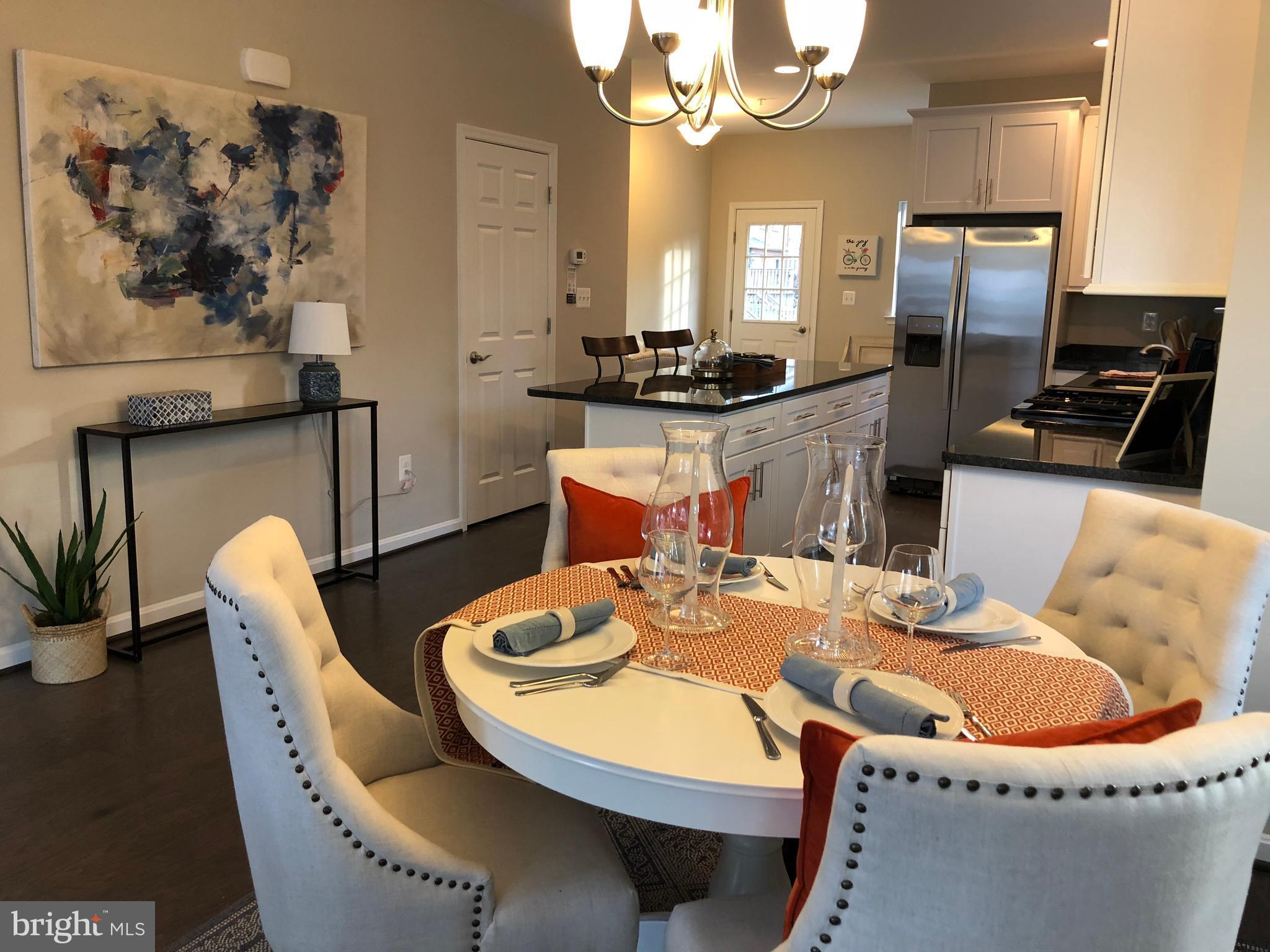 905 Cedarcroft Road Baltimore, MD 21212 - Photo 6 of 28 a dining room with furniture a large window and stainless steel appliances