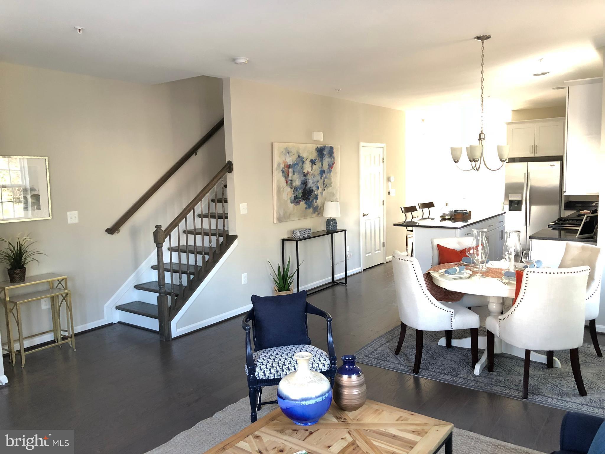 905 Cedarcroft Road Baltimore, MD 21212 - Photo 7 of 28 a view of a dining room with furniture a rug and wooden floor
