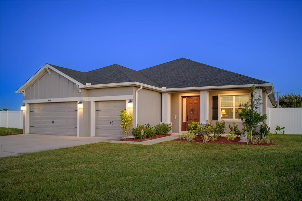 4444 Devinshire Fields Loop Plant City, FL 33567 - Photo 1 of 38 a front view of a house with garden