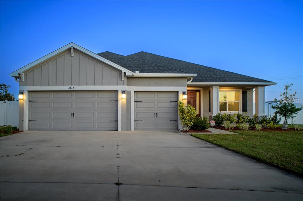 4444 Devinshire Fields Loop Plant City, FL 33567 - Photo 3 of 38 a front view of a house with a yard and garage