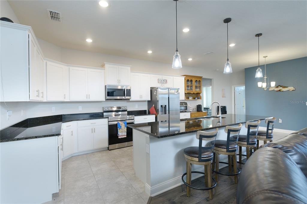 4444 Devinshire Fields Loop Plant City, FL 33567 - Photo 10 of 38 a large white kitchen with lots of counter space furniture and appliances