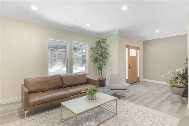 a living room with furniture and potted plant