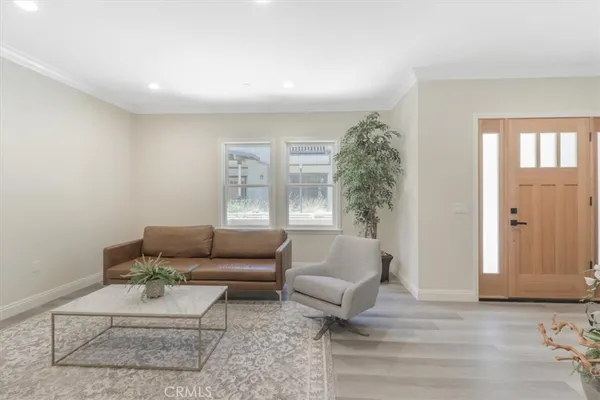 a dining room with furniture and wooden floor