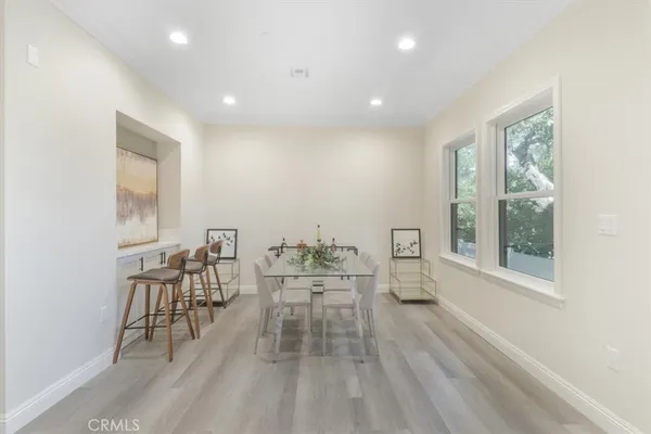 a dining room with furniture and wooden floor