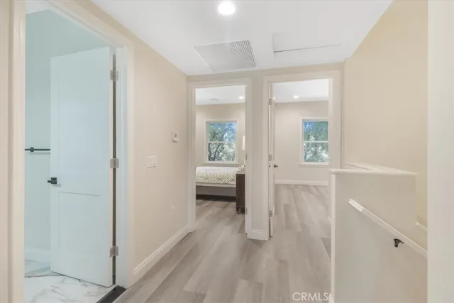 a bedroom with a bed and painting on the wall