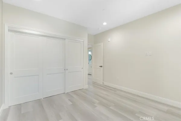 a bedroom with a bed and a night stand