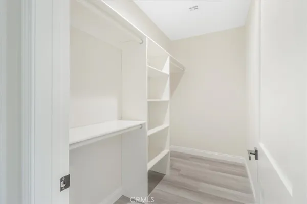 a view of a white building with swimming pool in front of it