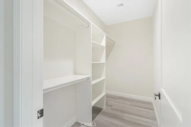 a view of a white building with swimming pool in front of it