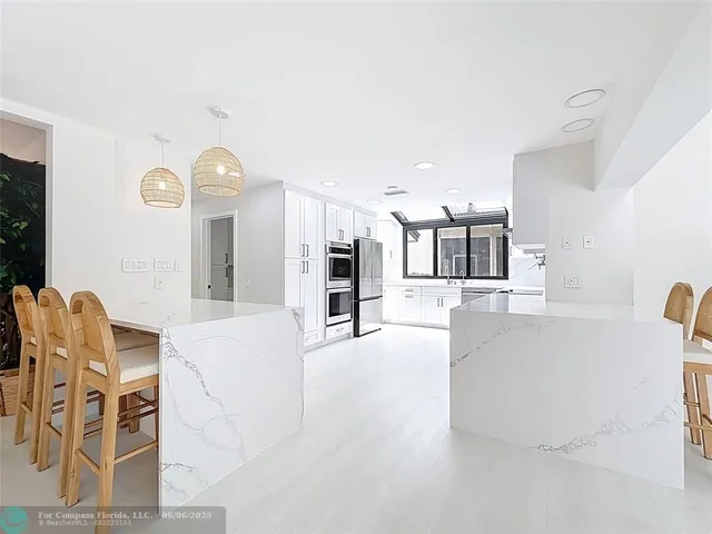 a kitchen with cabinets and stainless steel appliances