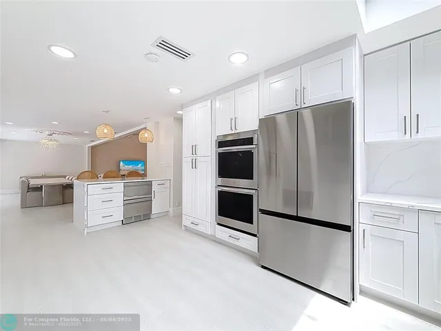 a living room with furniture large window and flat screen tv