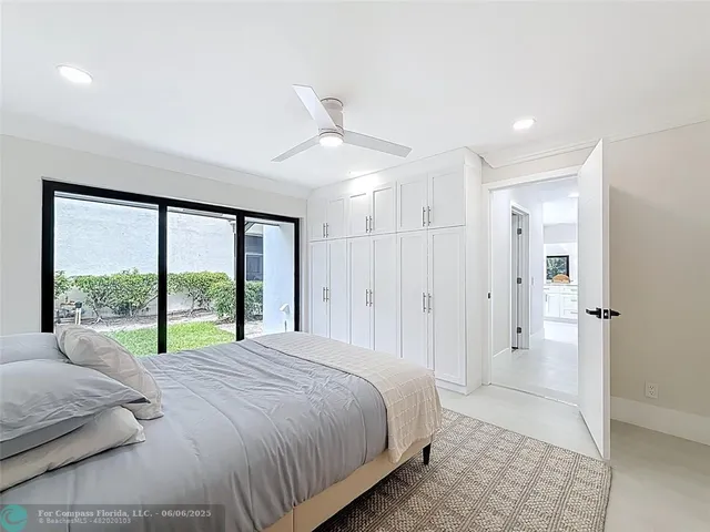 a bedroom with a bed and a large window